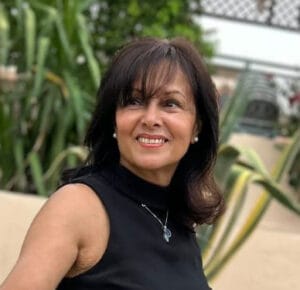 Celebrant Services | A brunette woman smiling while looking away from the camera.