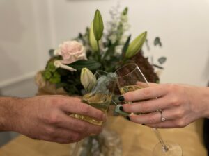 Celebrant Services | Two hands holding champagne glasses.